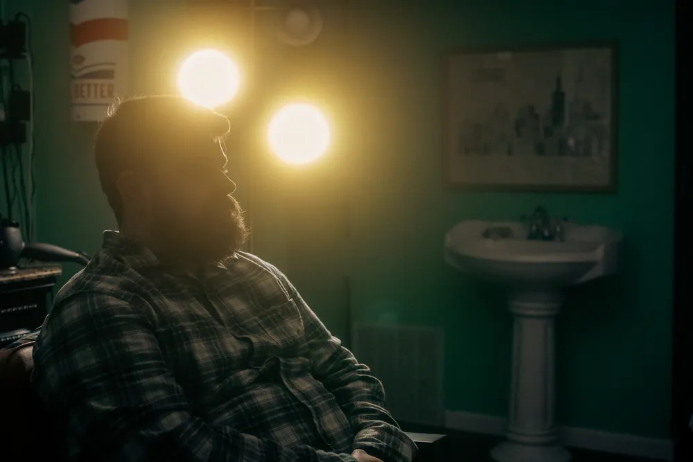 Owner sitting under halated lights