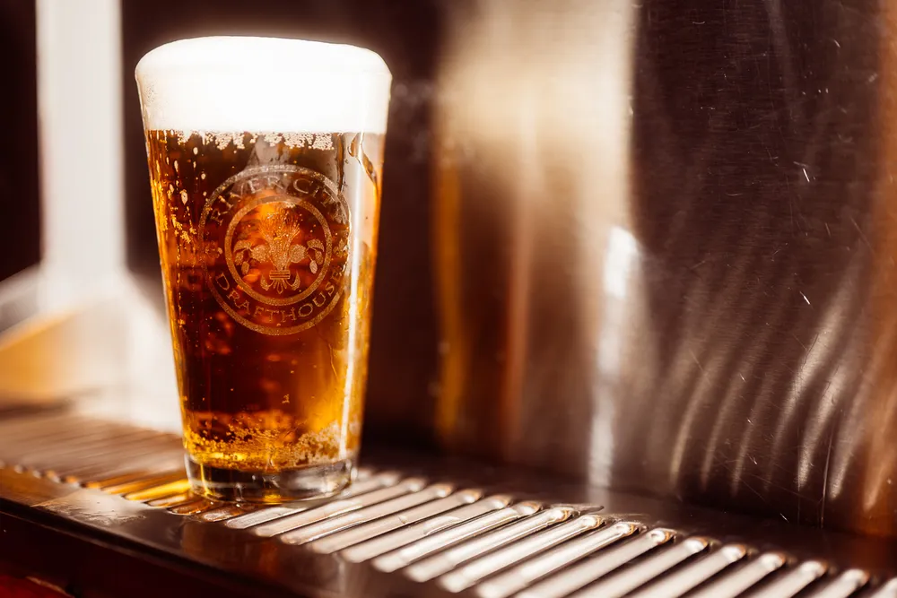 a beer sitting under the taps